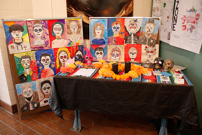 Student artwork decorates an ofrenda