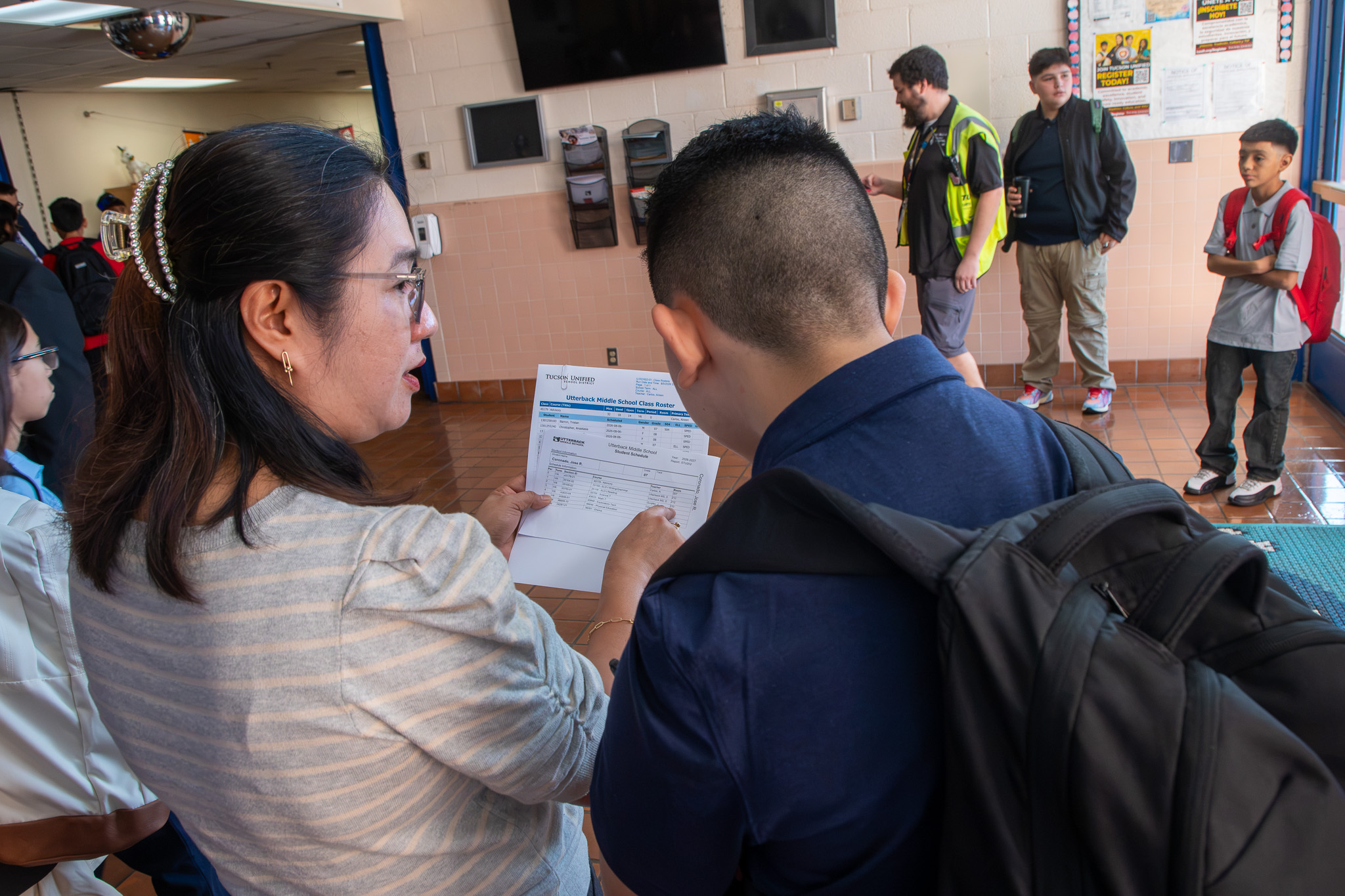 A woman works with a student to figure out his class schedule